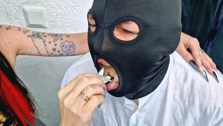 Brunette Dominatrix Nika smokes cigarette on balcony and uses slave man as her ashtray